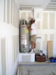 technician prepares to install a 40 gallon Bradford White water heater